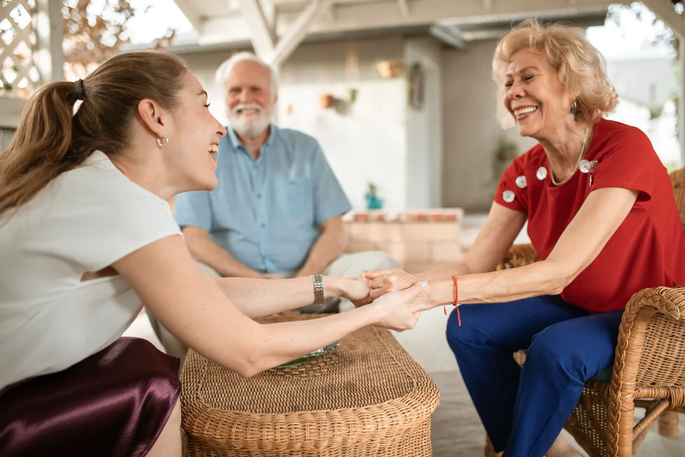 Three adults sharing a warm conversation together